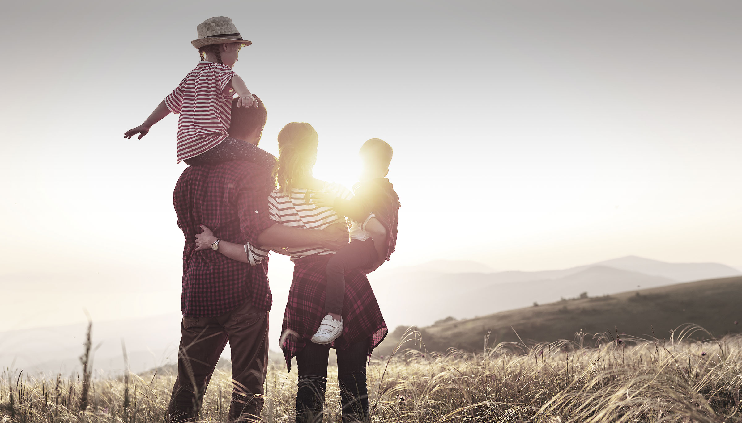 Family in a field with sunset